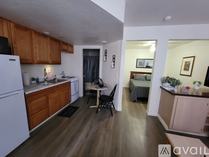 A kitchen with wooden cabinets and a white refrigerator.