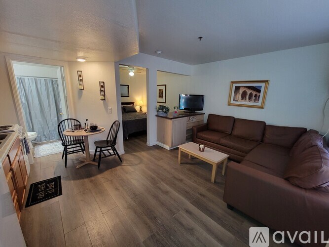 A living room with a brown couch and a television.