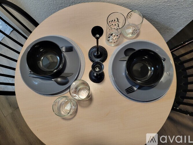A table with two cups and glasses on it.