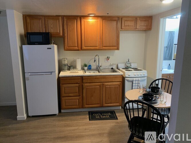 A kitchen with wooden cabinets and a white refrigerator.