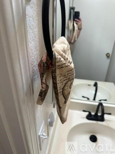 A towel with a pattern hangs on a towel ring.