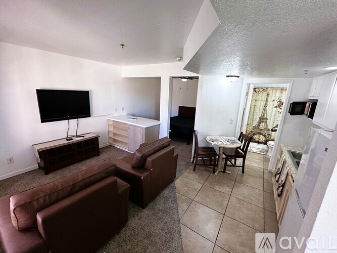 A living room with a brown couch and a television.
