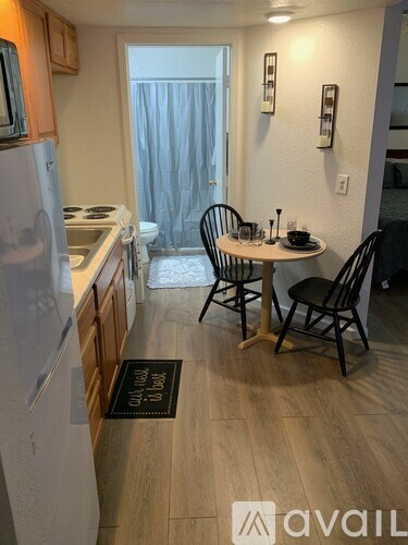 A kitchen with a table and chairs in the middle of the room.