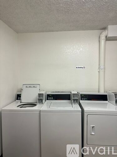 A row of washing machines are available for rent.