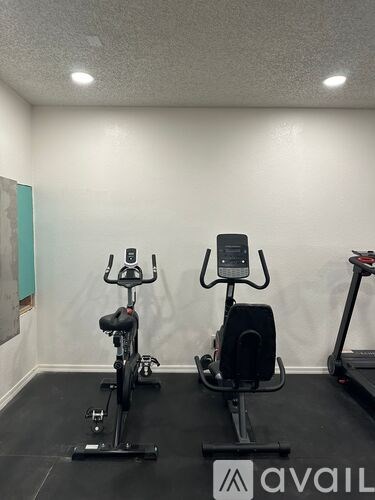 Two exercise bikes are in a room with Avail branding.