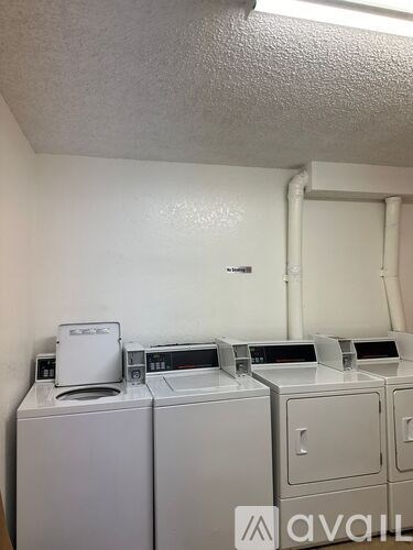 A row of washing machines in a laundromat.