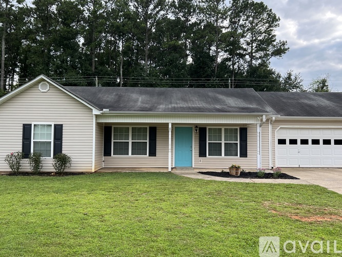 A house with a blue door and a white garage door.