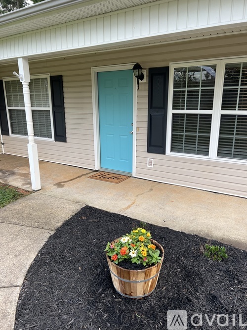 A blue door is on the right side of a house.