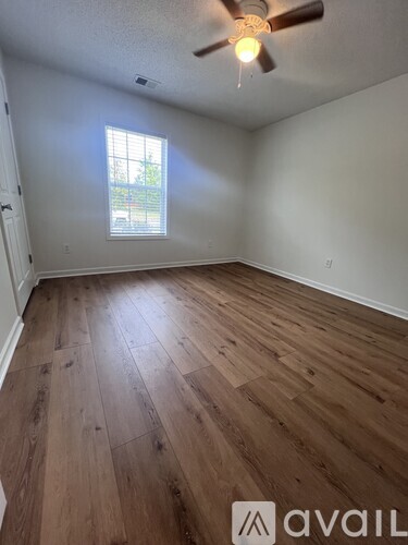 A dining room with a wooden table and chairs.