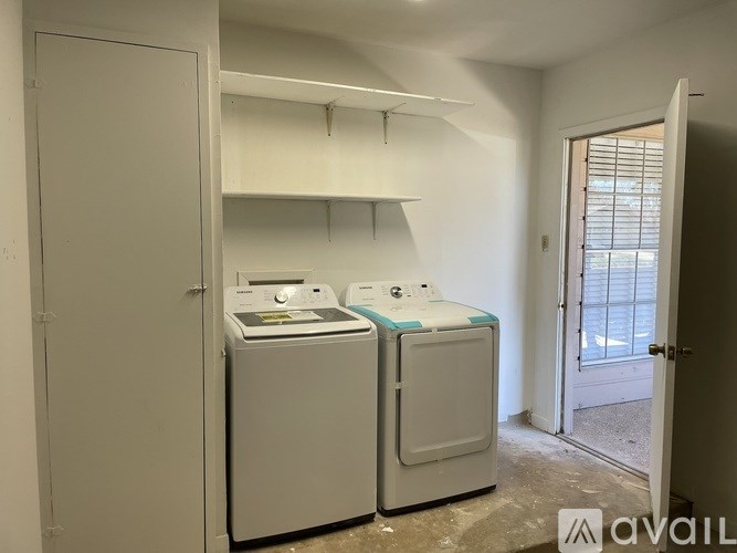 Two front loading washing machines in a laundry room.
