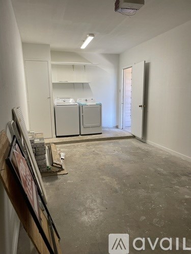 A room with a floor that is under construction and a framed picture on the wall.