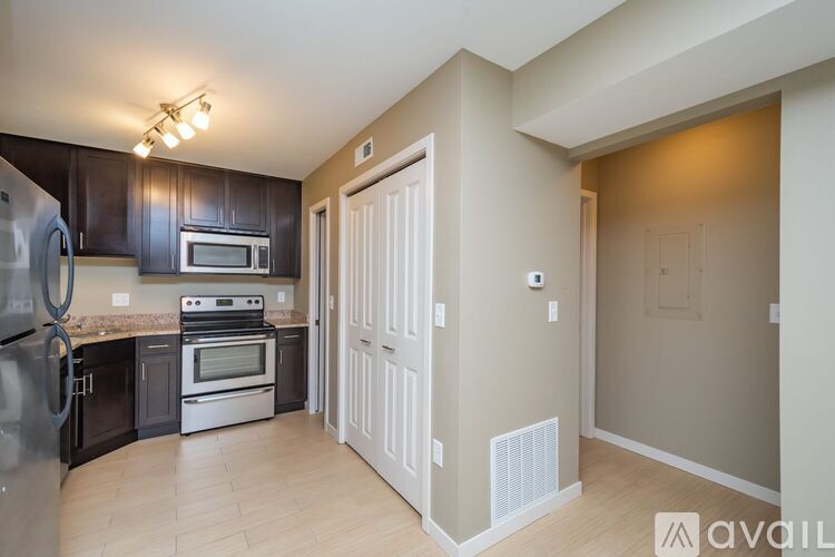 A kitchen with black cabinets and stainless steel appliances.