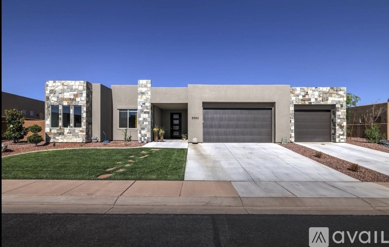 A modern house with a stone facade and a large garage door.