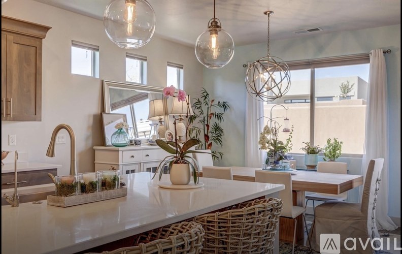 A kitchen with a large island and a dining table.