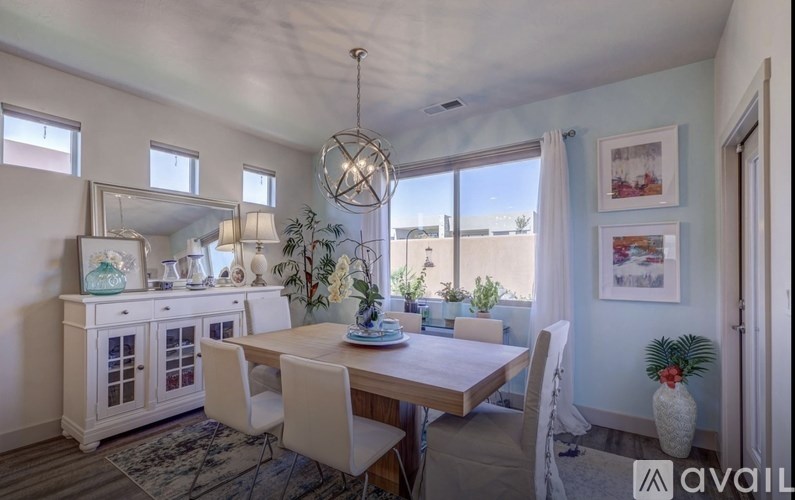 A dining area with a wooden table and chairs.