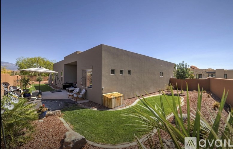 A modern house with a patio and a garden.