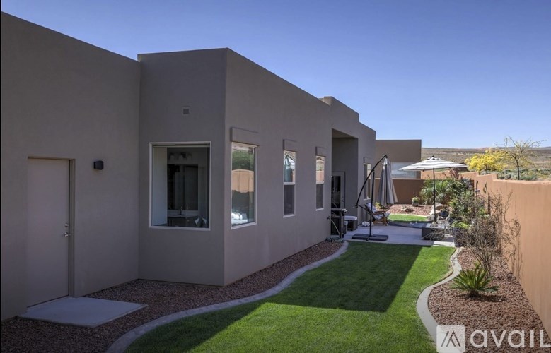 A modern house with a garden in front.