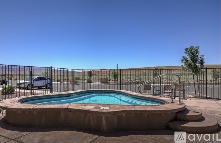 A small pool surrounded by a fence.