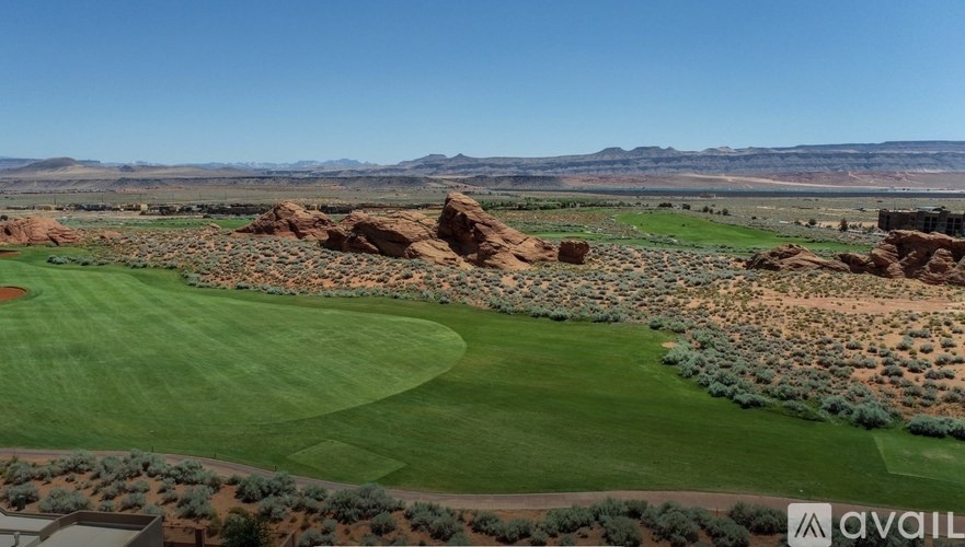 A golf course with a green and a rocky area.