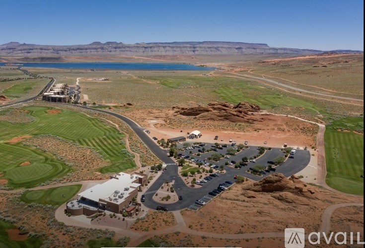 A bird's eye view of a golf course with a lake and a building.