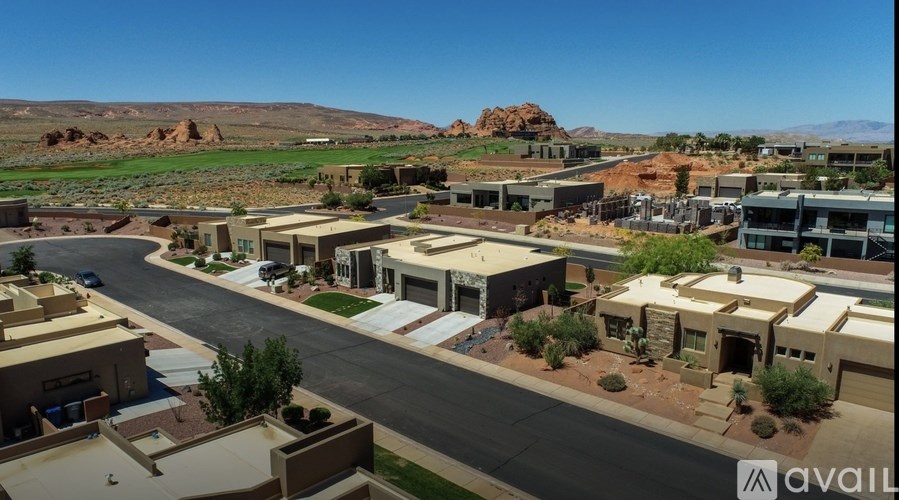 A sunny day in a residential area with houses and roads.