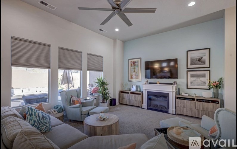 A living room with a couch, a coffee table, and a fireplace.