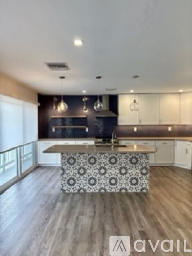 A modern kitchen with a patterned island bench.