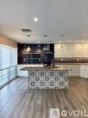 A modern kitchen with a patterned island bench.