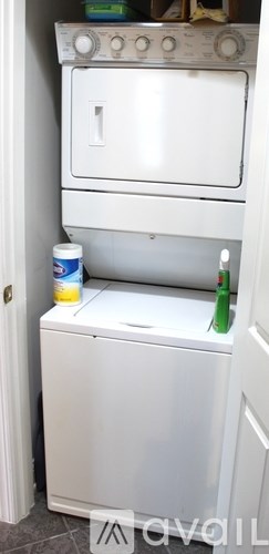 A white oven and dishwasher are stacked on top of each other.