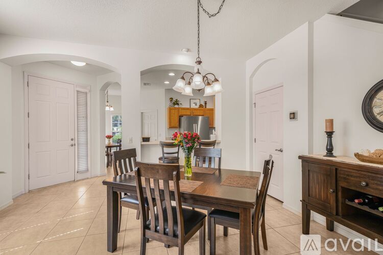 A dining room with a table set for six.