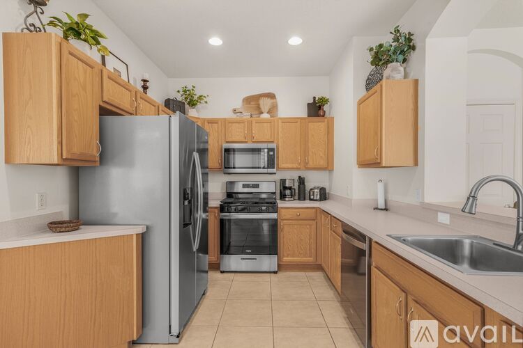 A kitchen with wooden cabinets and a refrigerator.