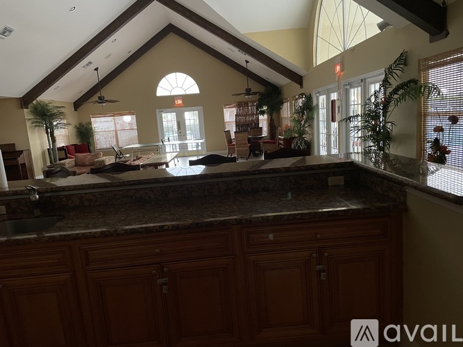 A kitchen with wooden cabinets and a granite countertop.