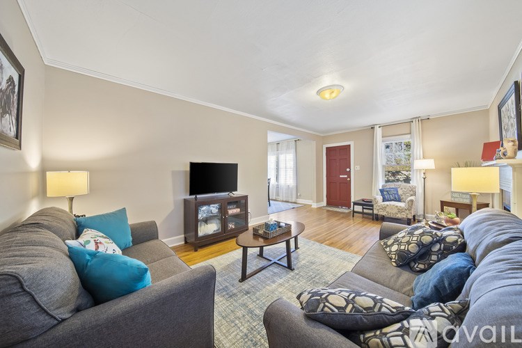 A living room with a grey couch and a wooden coffee table.