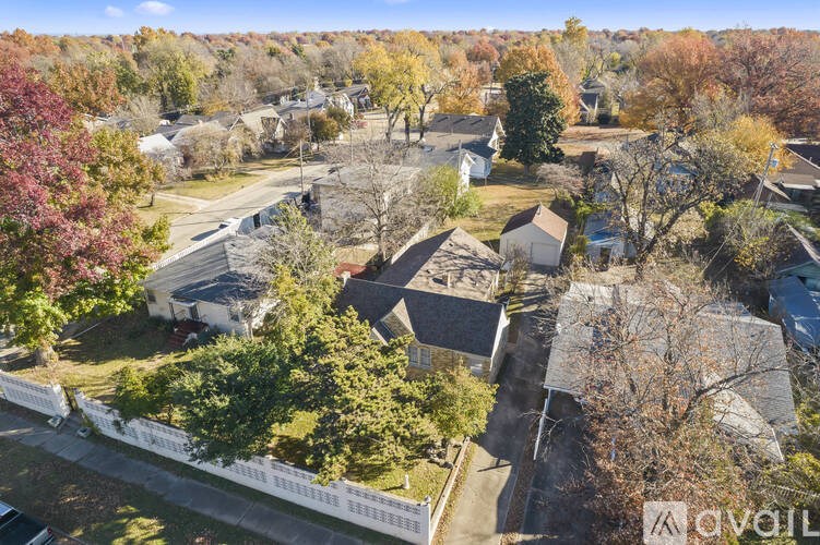 A suburban neighborhood with houses and trees in autumn colors.