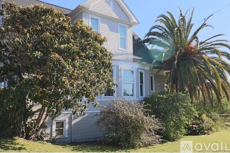 A house with a tree in front of it.
