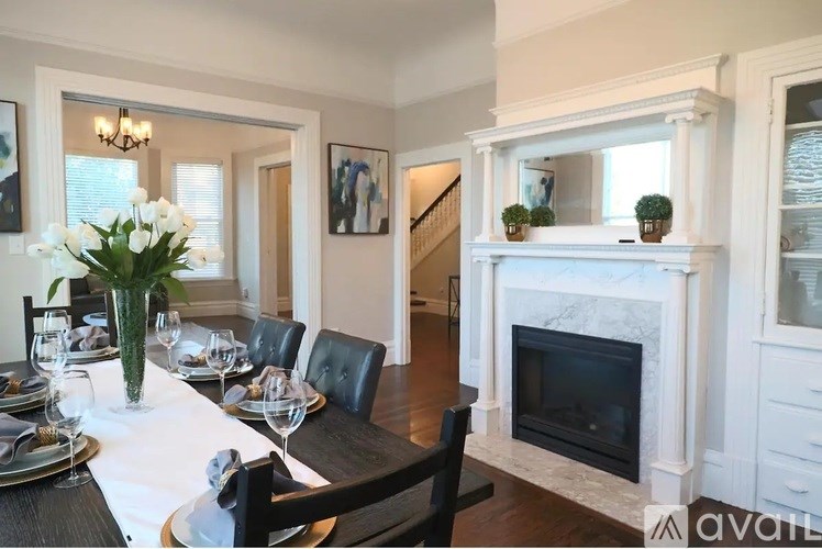 A dining room with a table set for a meal.