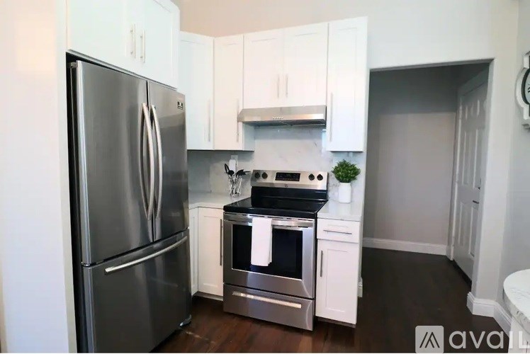 A kitchen with a stainless steel refrigerator and oven.
