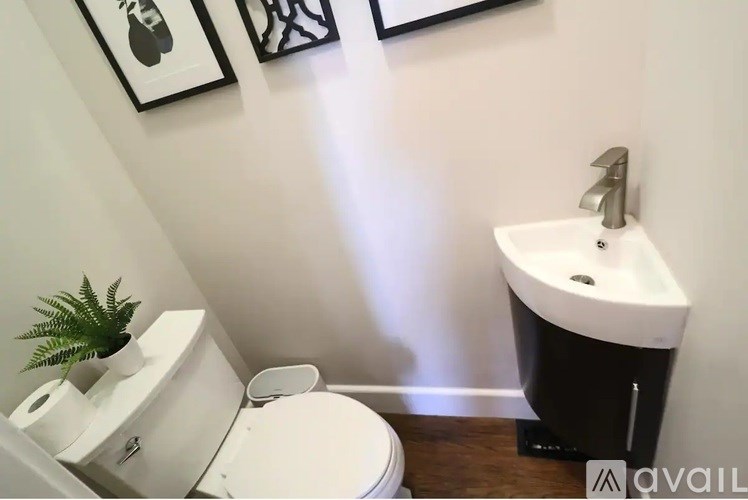 A white toilet sits next to a sink in a bathroom.
