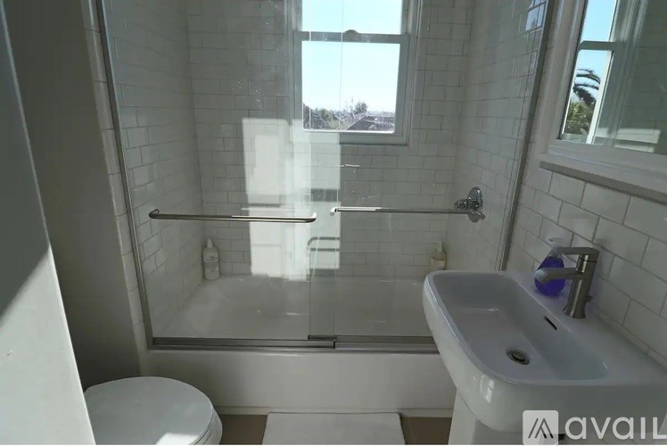 A bathroom with a toilet, sink, and bathtub.
