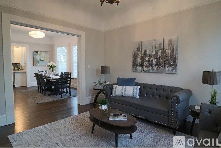 A living room with a grey couch and a coffee table.