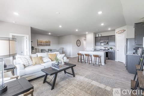 A modern living room with a white sofa and a coffee table.