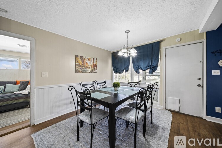 A dining room with a table set for four.
