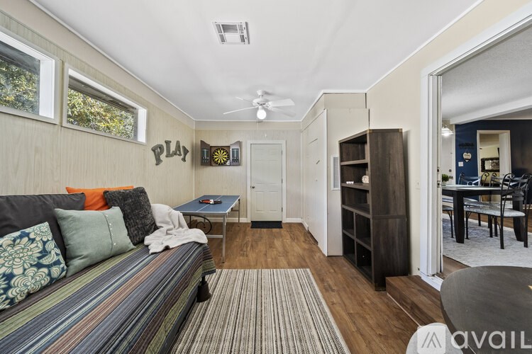 A living room with a striped couch and a small table.