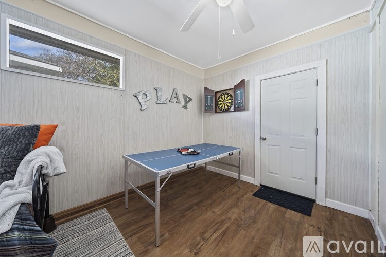 A room with a table, chairs and a window.