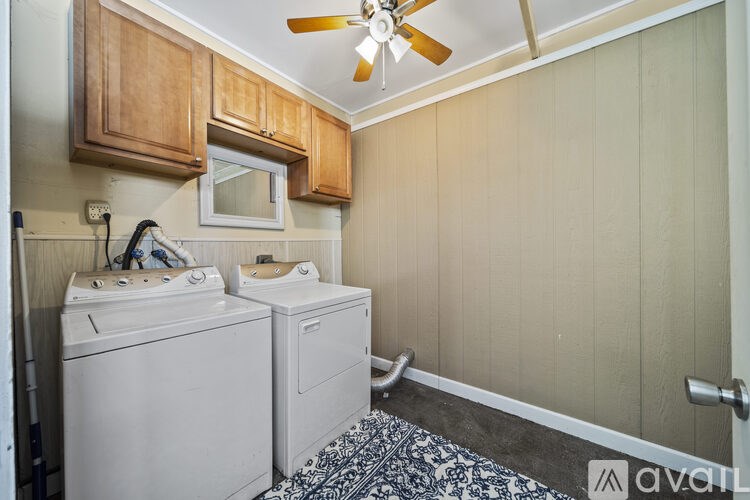 A small laundry room with a washer and dryer.