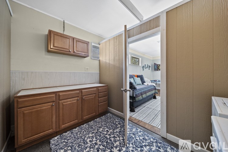 A room with a wooden cabinet and a black and white patterned carpet.
