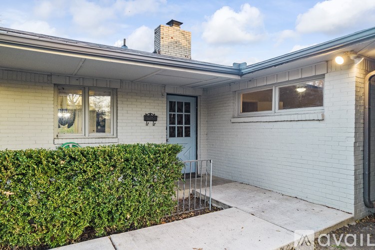 A house with a blue door and a grey garage door.