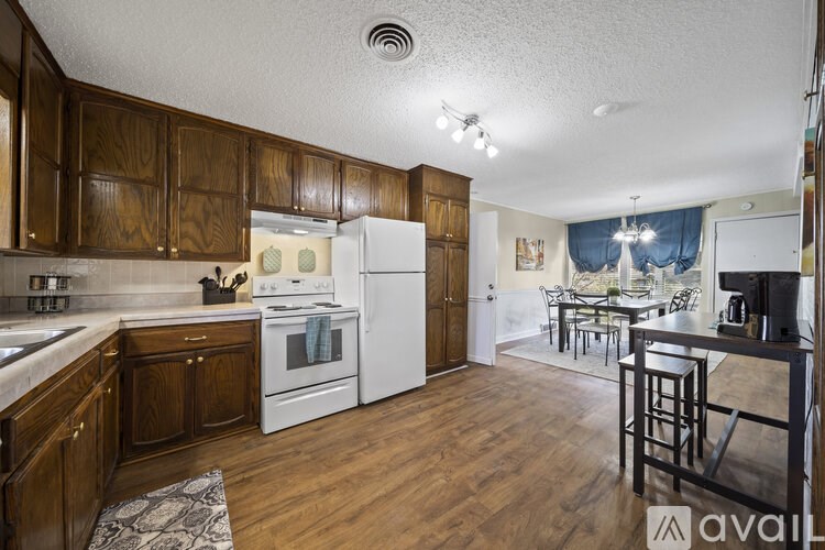 A kitchen with wooden cabinets and a white refrigerator.