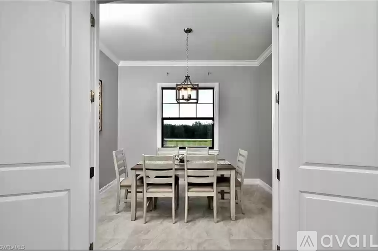 A dining room with a table set for four.