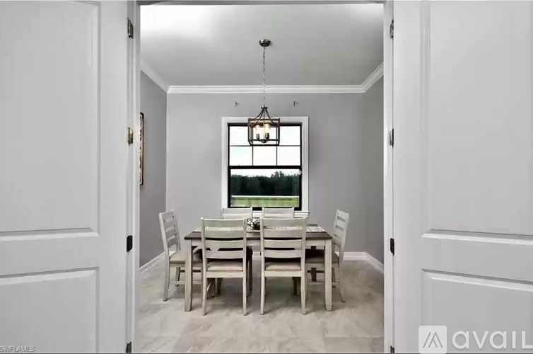 A dining room with a table set for four.